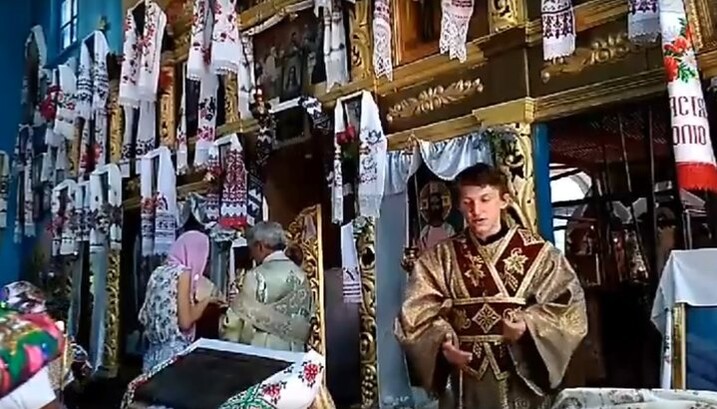 A "priest" of the Kiev Patriarchate sterilizing a communion spoon in the flame of a candle
