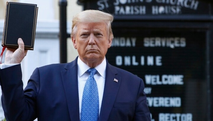 Donald Trump at the entrance of the church, holding a Bible. Photo: ndtv